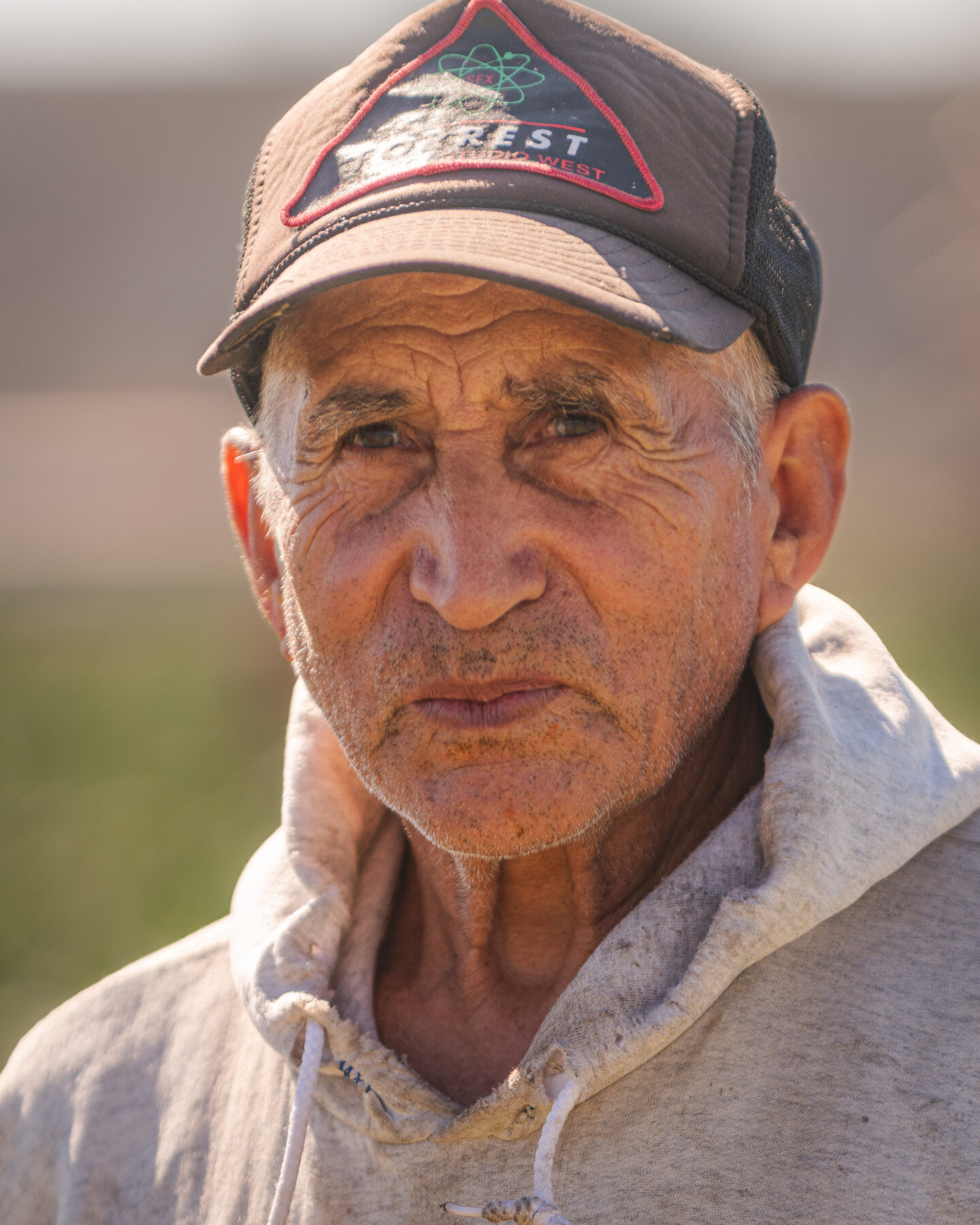 Senior farmworker in a Forrest cap, close-up portrait